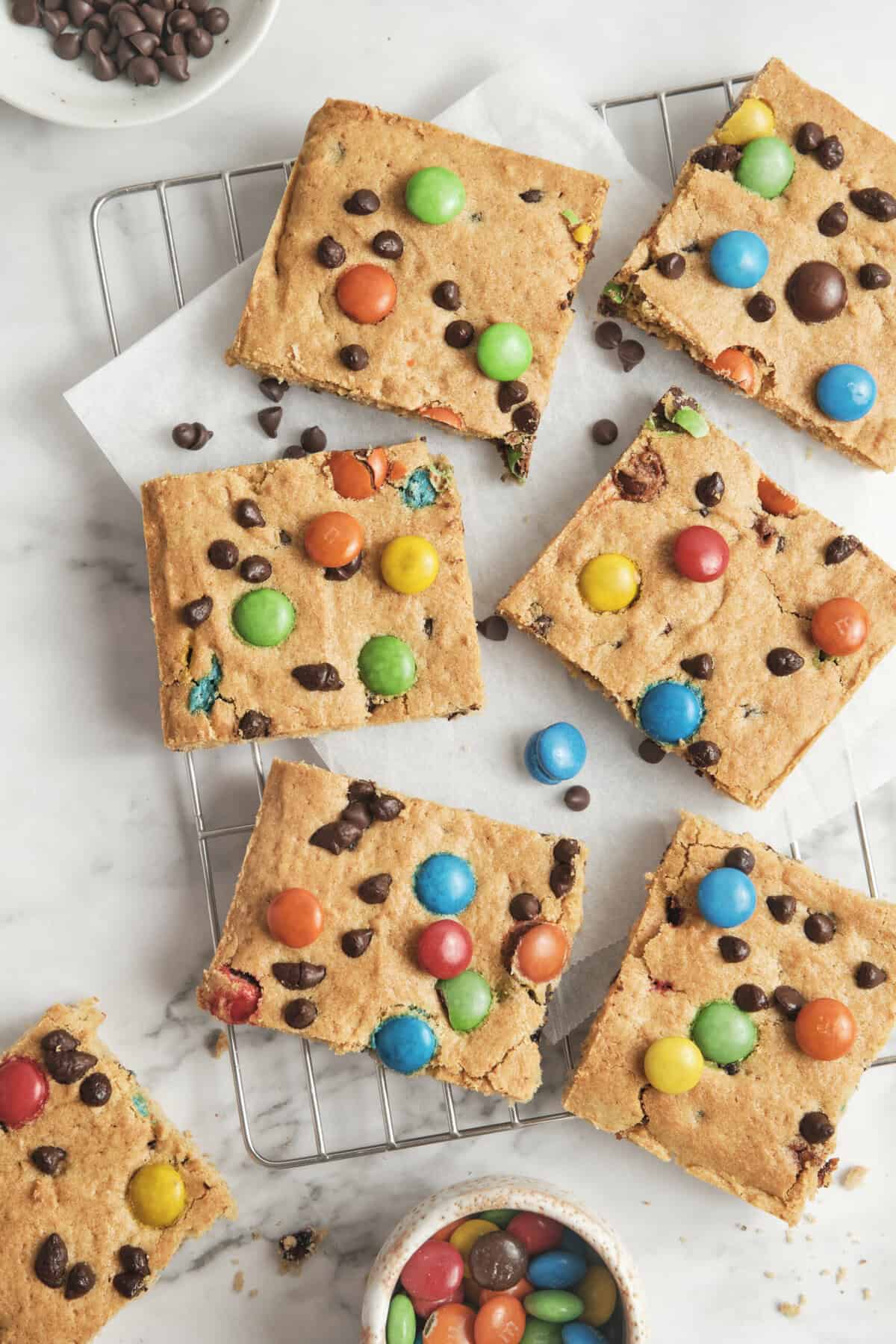 Chewy, gluten-free cookie bars with colorful M&M candies, chocolate chips, and a buttery texture, perfect for a nutritious treat or snack. Great for gluten-free diets and healthy eating.
