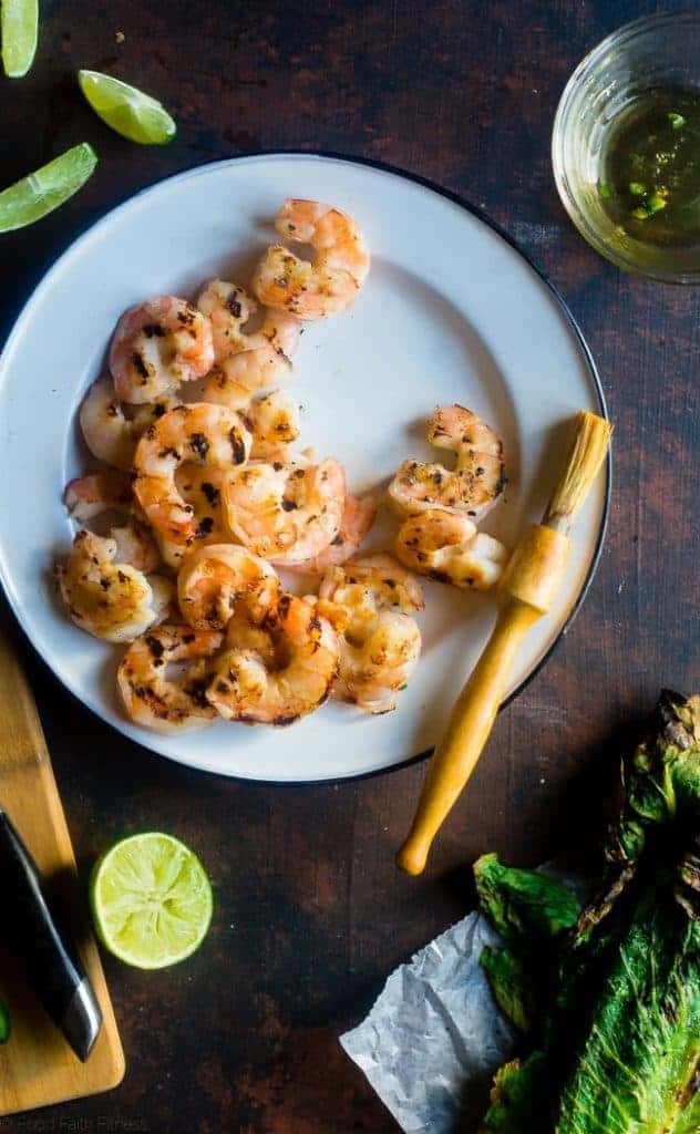 Honey Lime Grilled Avocado Shrimp Nacho Bowls - These smoky-sweet bowls have glazed honey lime grilled avocado, spicy shrimp. tomato and corn! Top them with gluten free nacho chips for a healthy, summer meal that's packed with flavor! | Foodfaithfitness.com | @FoodFaithFit