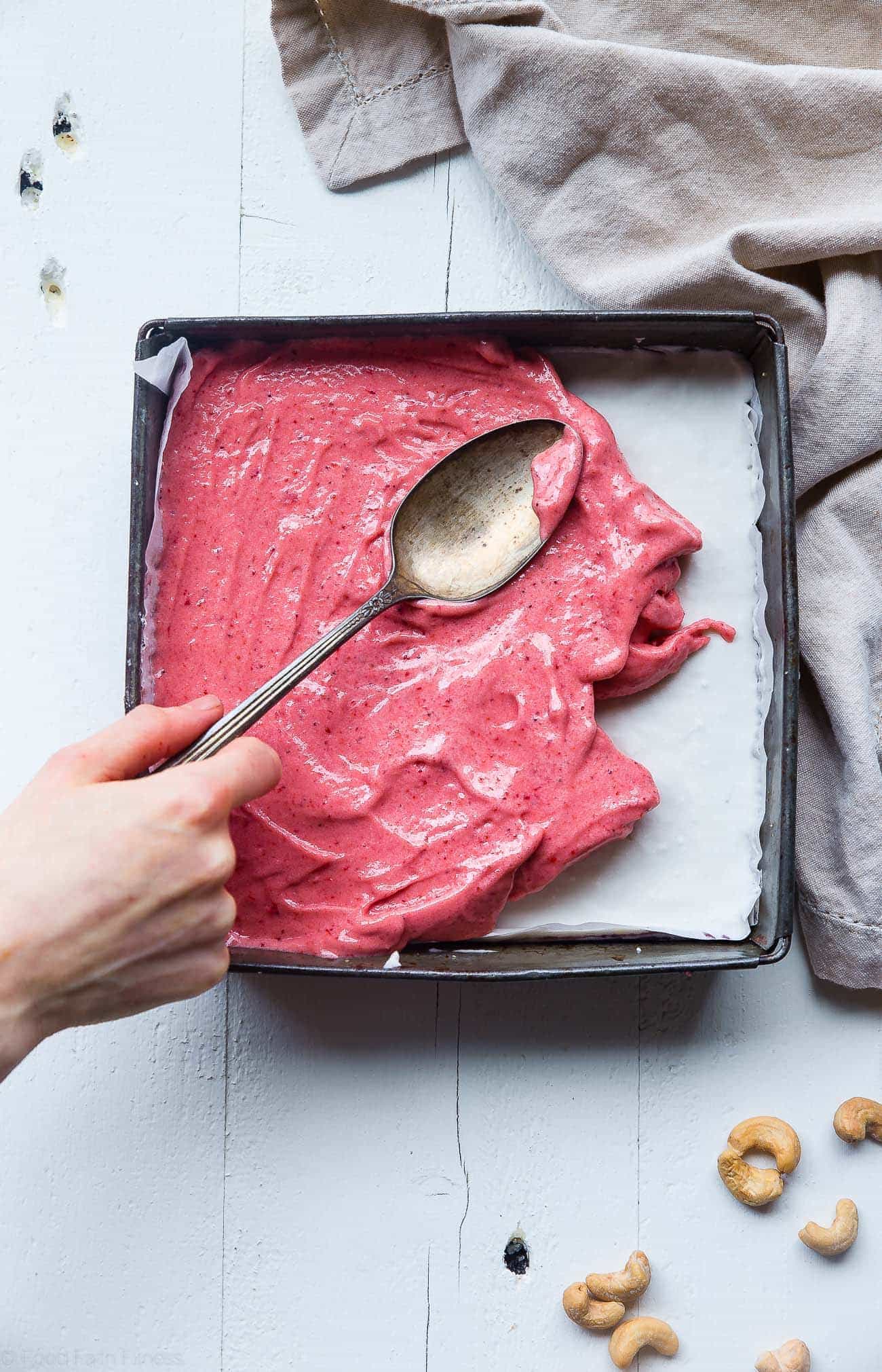 Spreading banana ice cream in pan. Recipe at foodfaithfitness.com