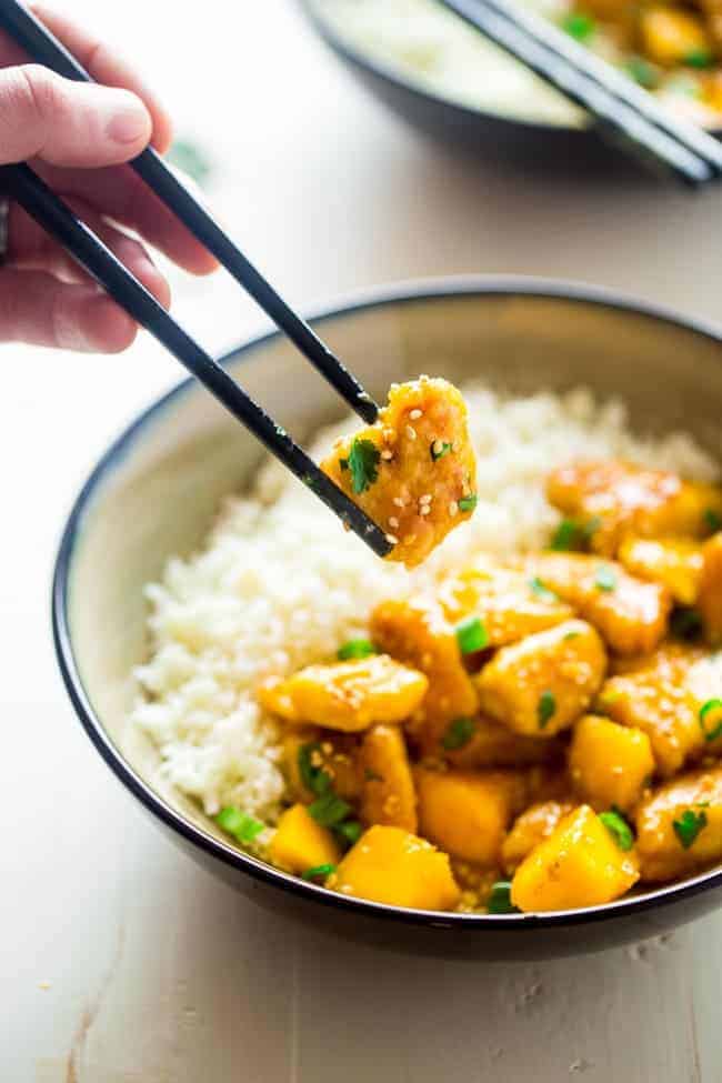 Whole 30 Mango Chicken with Coconut Cauliflower Rice - This paleo mango chicken is served over coconut cauliflower rice for a quick, easy and healthy spin on take-out that is ready in 30 mins! Recipe has a vegan option too! | Foodfaithfitness.com | @FoodFaithFit