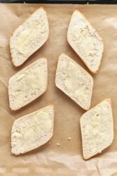 Fluffy bread slices with butter spread, perfect for healthy snack or breakfast options, showcased on parchment paper for a clean presentation.