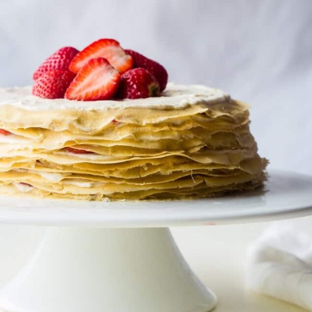 Strawberry Lemon Paleo Crepe Cake with Coconut Cream - This cake is made out of paleo crepes layered with rich, sweet lemon coconut cream and fresh strawberries. It's a gluten free dessert, that's perfect for a spring brunch or Mothers day! | Foodfaithfitness.com | @FoodFaithFit