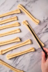 Golden homemade gluten-free breadsticks on marble surface, easy healthy snack, perfect for diet-friendly recipes and nutritious meal ideas.